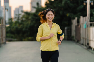 beautiful young asia athlete lady running exercises work out urban environment japanese teen girl wearing sports clothes walkway bridge early morning lifestyle active sporty city