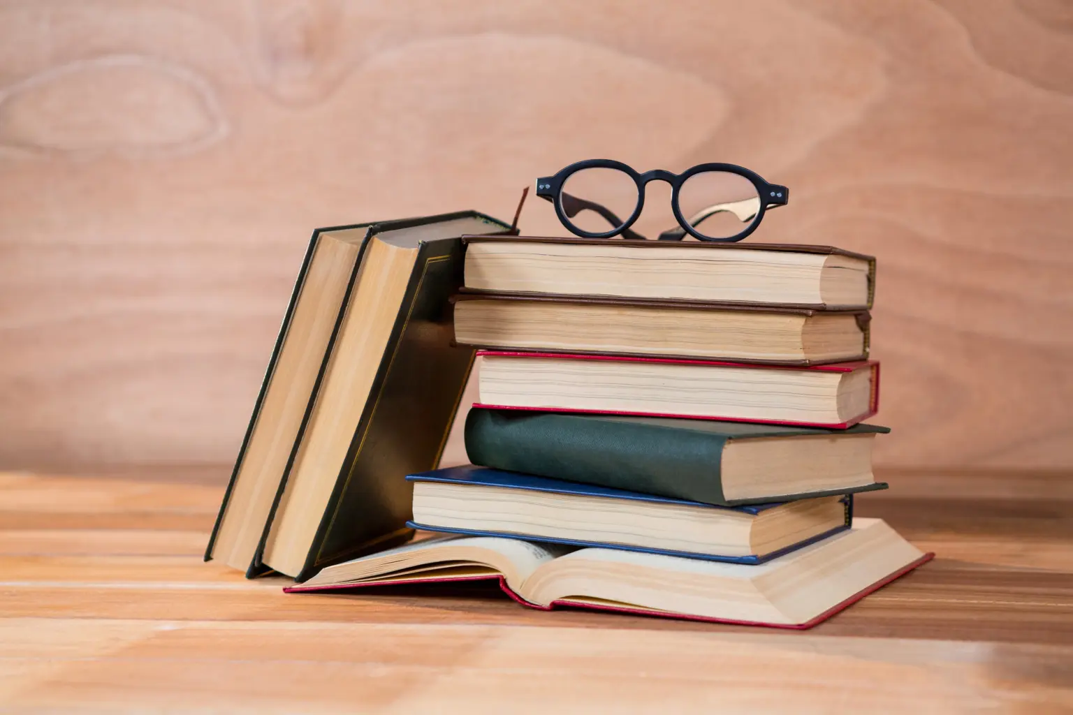 various books with spectacles table