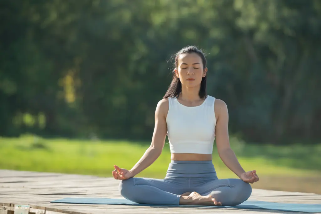woman yoga mat relax park mountain lake calm woman with closed eyes practicing yoga sitting padmasana pose mat lotus exercise attractive sporty girl sportswear
